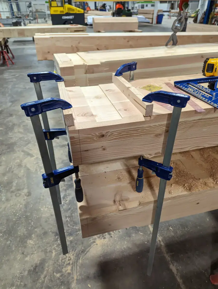 Timber beam with a routed channel using the naive setup held by the bar clamps